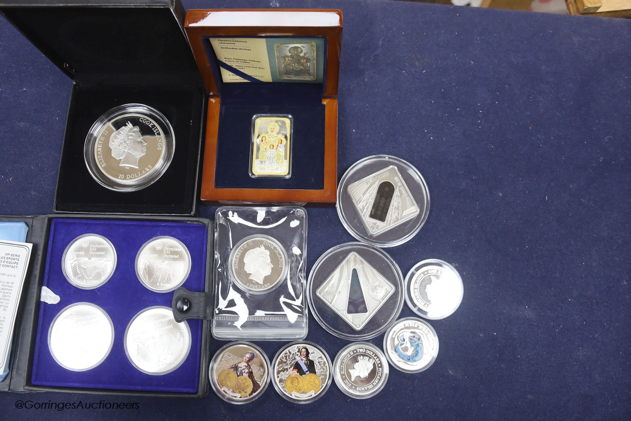 A group of silver proof coins, to include a JVP boxed orthodox shines $2, a Masterpieces of Art Cook Islands $20, a set of 1976 Montréal Olympics coins, a Cook Islands $5, three half ounce silver proof coins, a Niue Isla